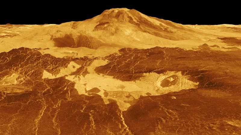 Active Venus volcanoes: Tall bright yellow and brown mound with brighter patches and crack-like lines around it.